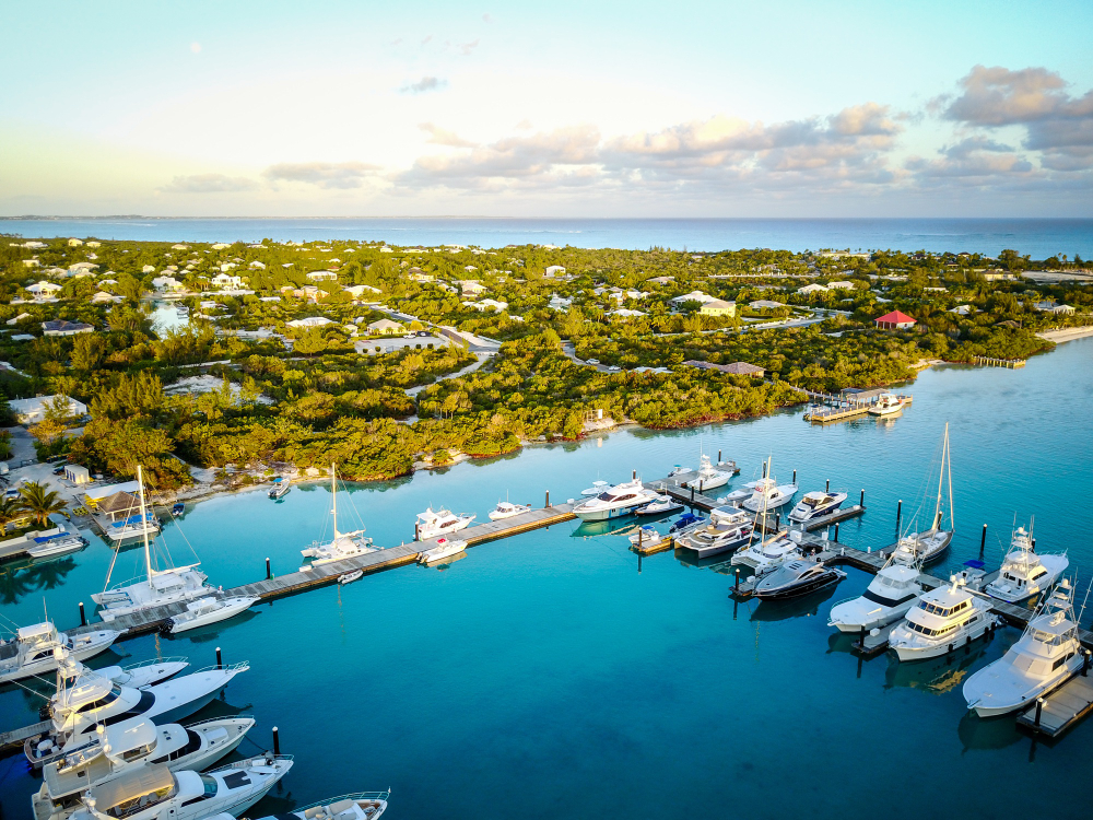 Aerial view of marina with yachts and tropical coastline