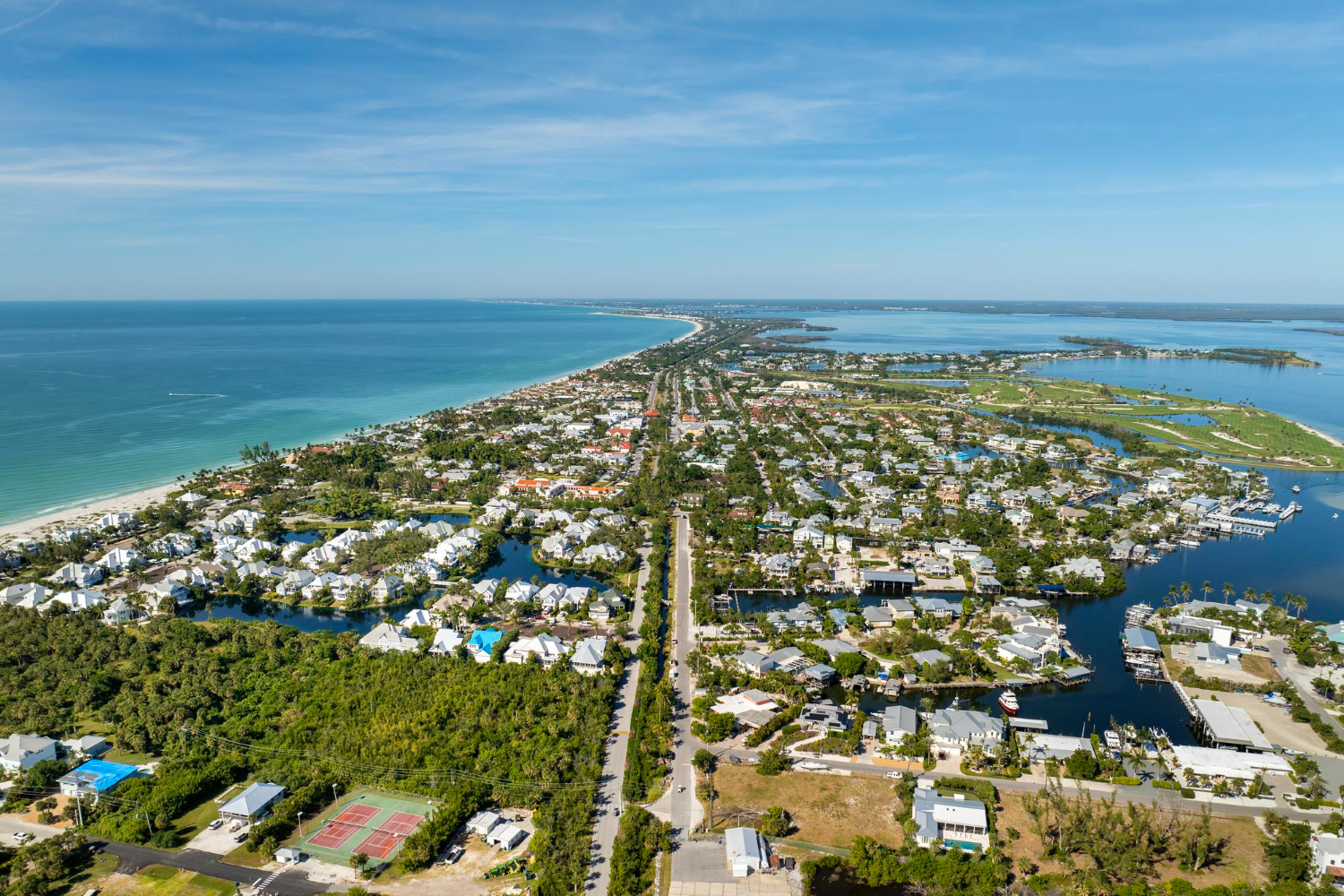 Aerial view of coastal neighborhood with ocean and canals