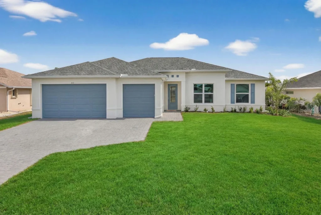 Single-story home with three-car garage and green lawn