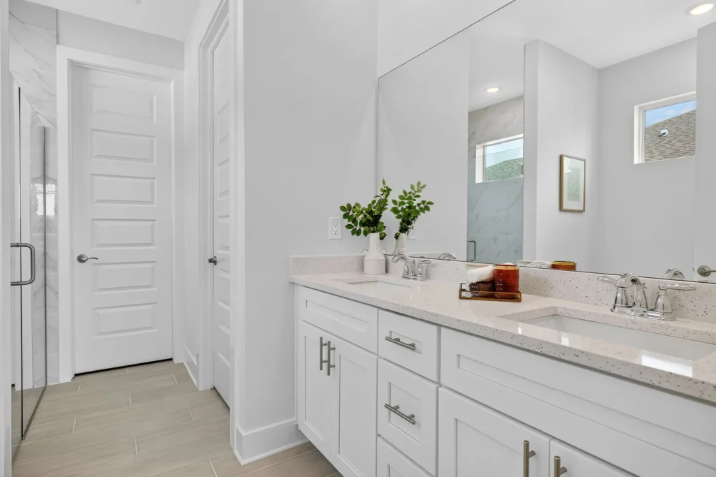 Modern bathroom double vanity with large mirror and shower