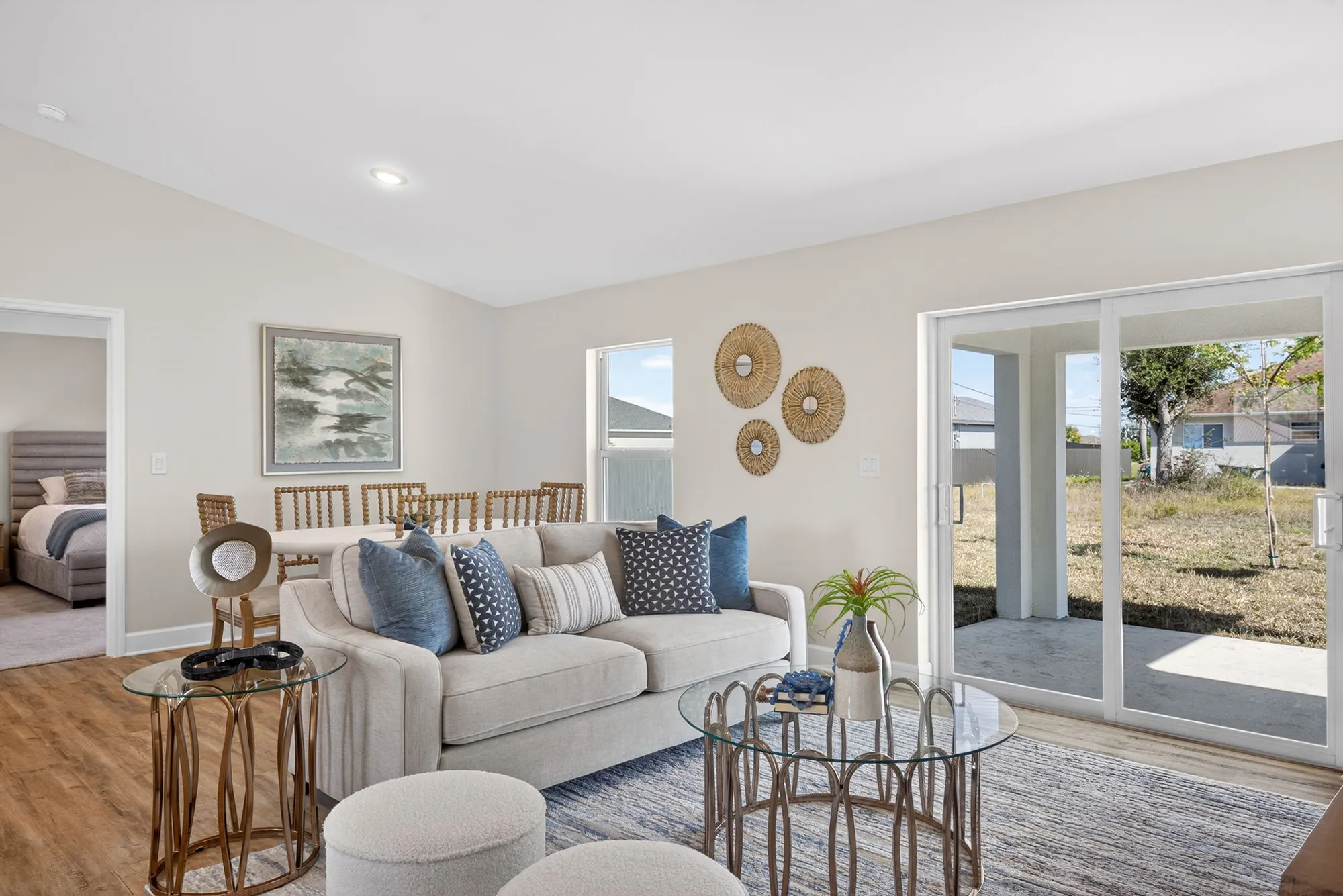 Living room with sofa, dining area, and sliding glass doors