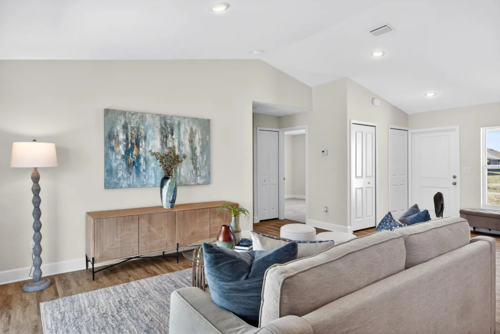 Modern living room with sofa, console table, abstract painting.