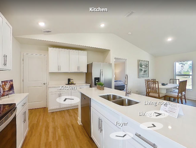 Bright kitchen with white cabinets and island sink