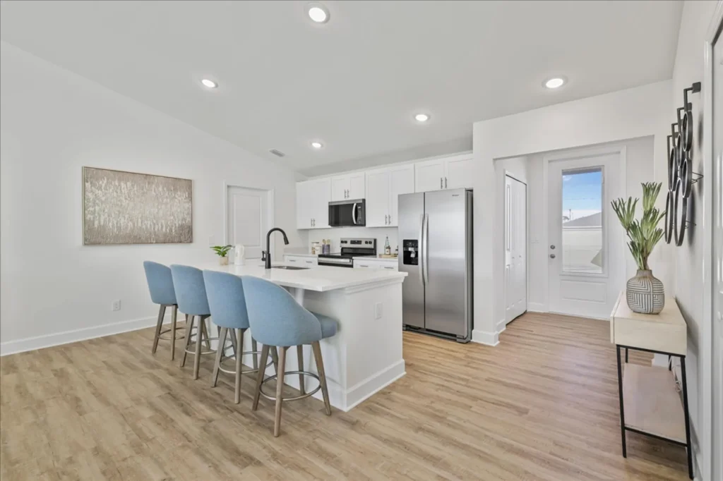 Modern white kitchen with island and four blue stools