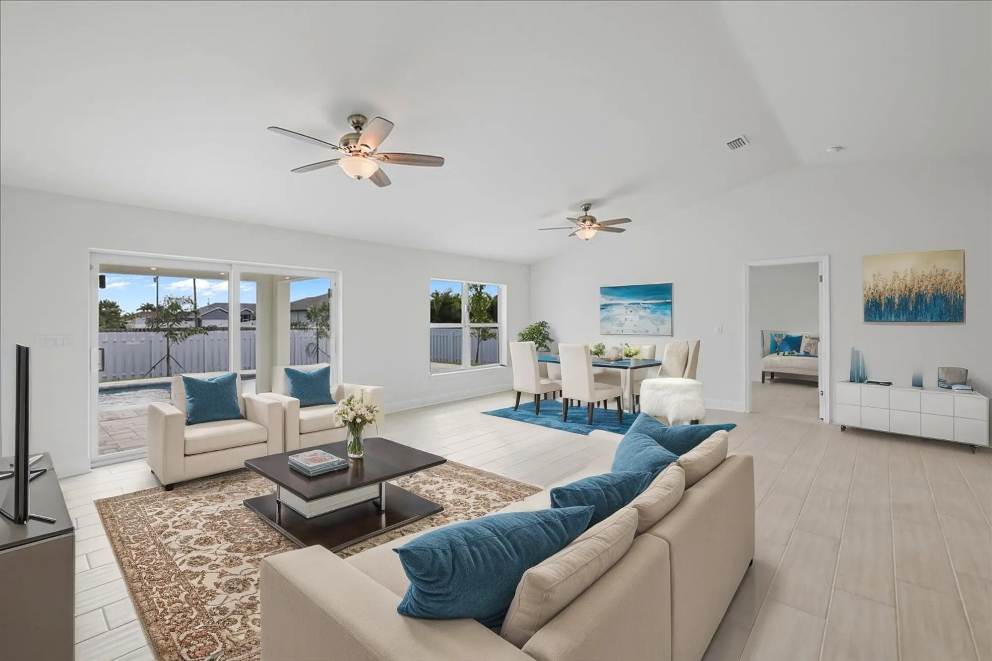 Open living room with sofa, dining table, and sliding doors