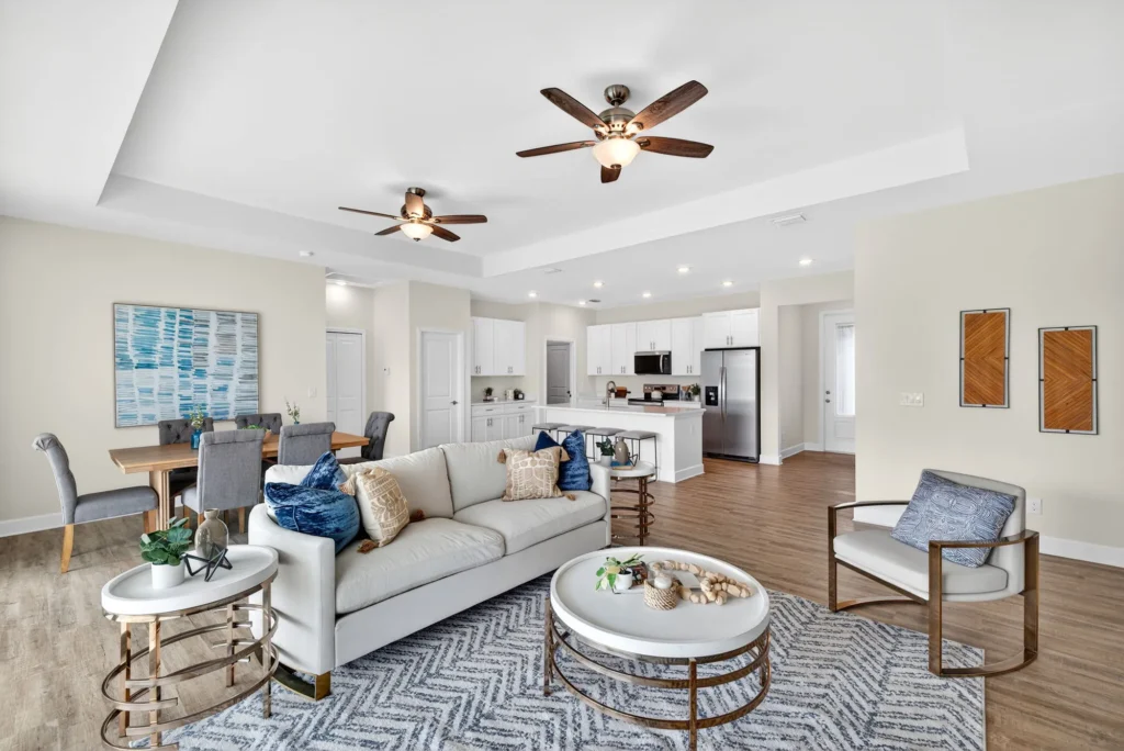 Open living room with sofa, dining area and kitchen.