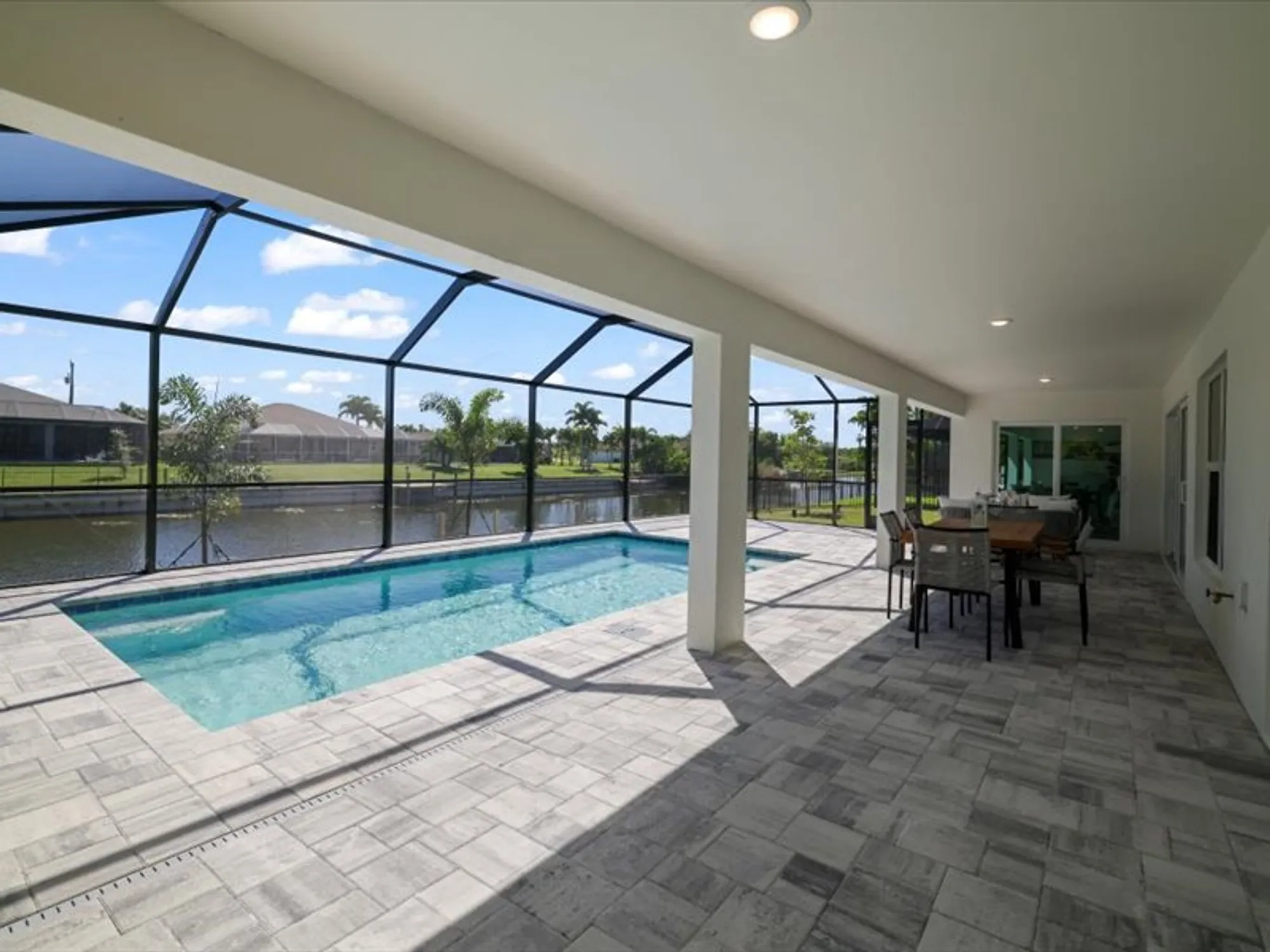 Screened lanai with pool and patio dining set