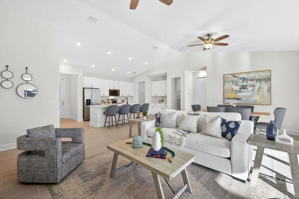 Open living room with white kitchen and sofa