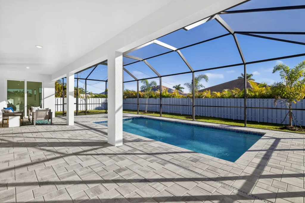 Screened lanai with swimming pool and covered patio seating