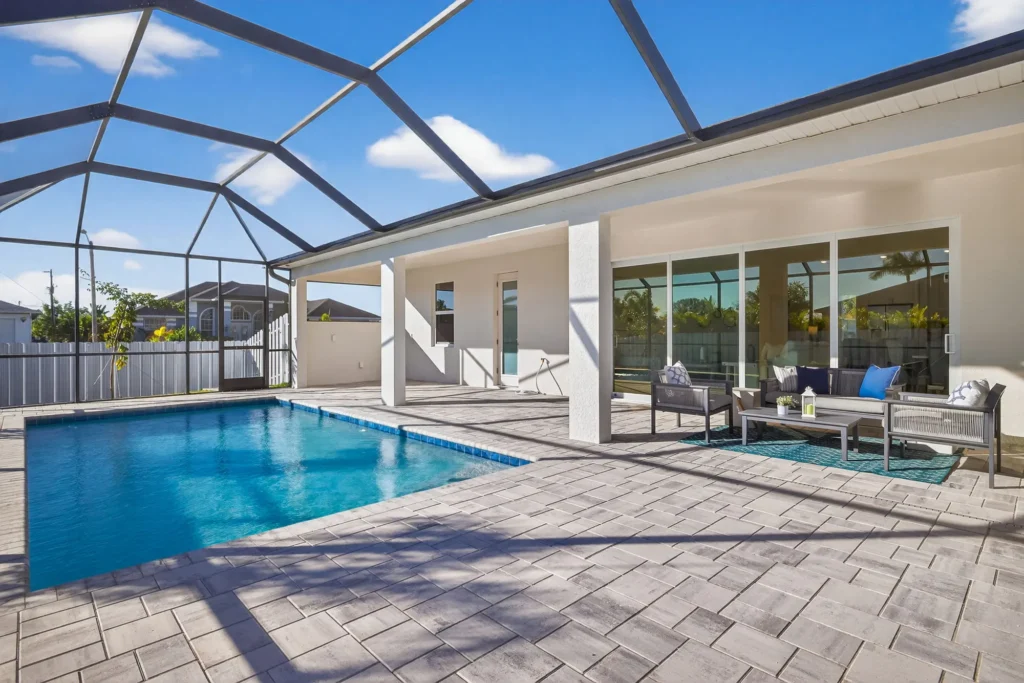 Screened backyard pool and patio with outdoor seating