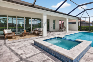 Screened patio with outdoor seating, pool, and spa.