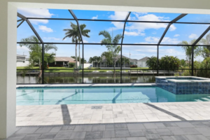 Screened patio with pool, spa, and canal view.