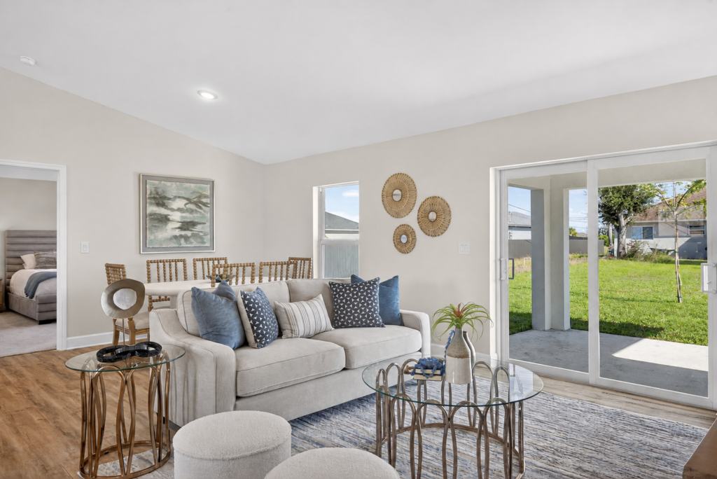 Staged living room with sofa and sliding glass doors