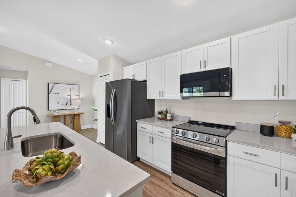 Modern kitchen with white cabinets and stainless steel appliances