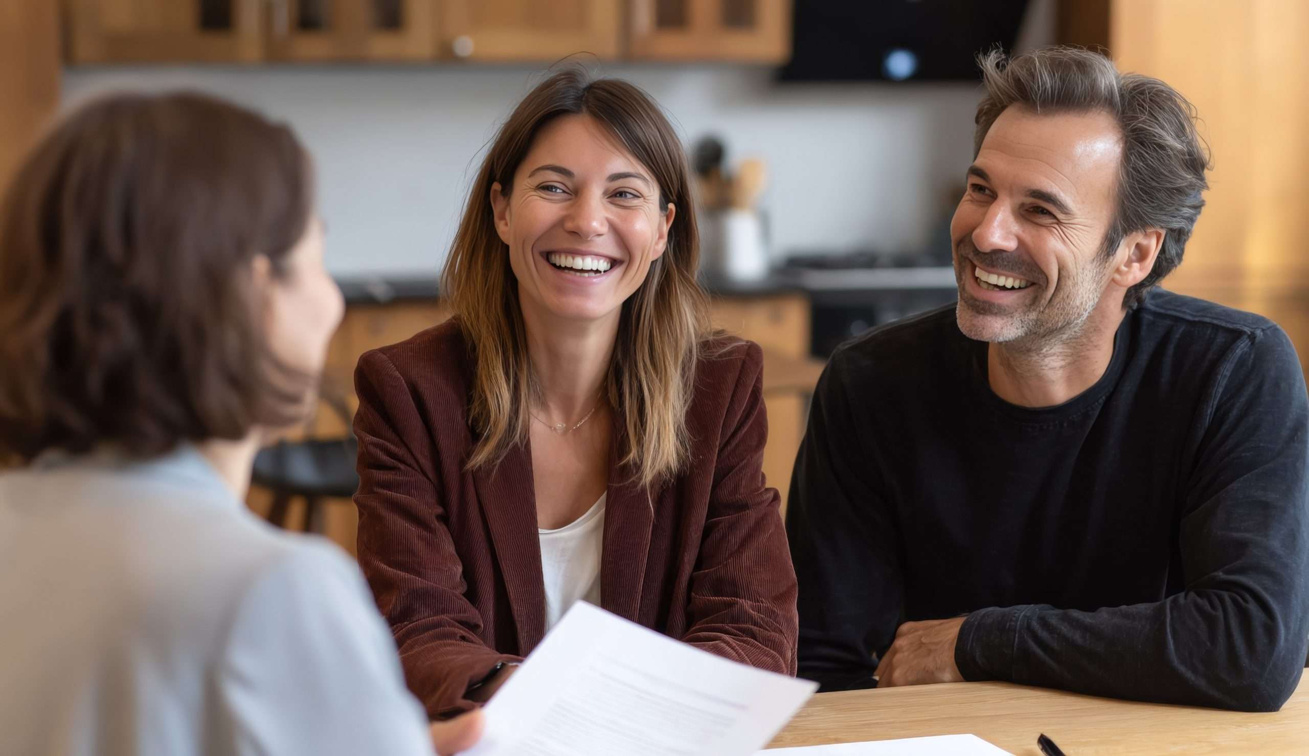 Couple meeting with a home advisor to review paperwork