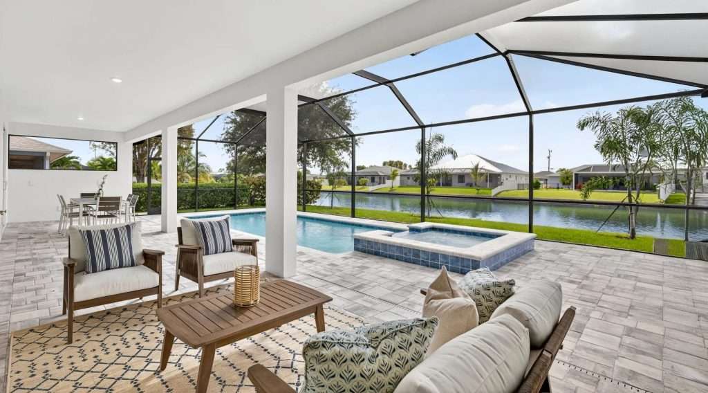 Lanai with pool and spa overlooking a canal at a SunLife Coral Haven