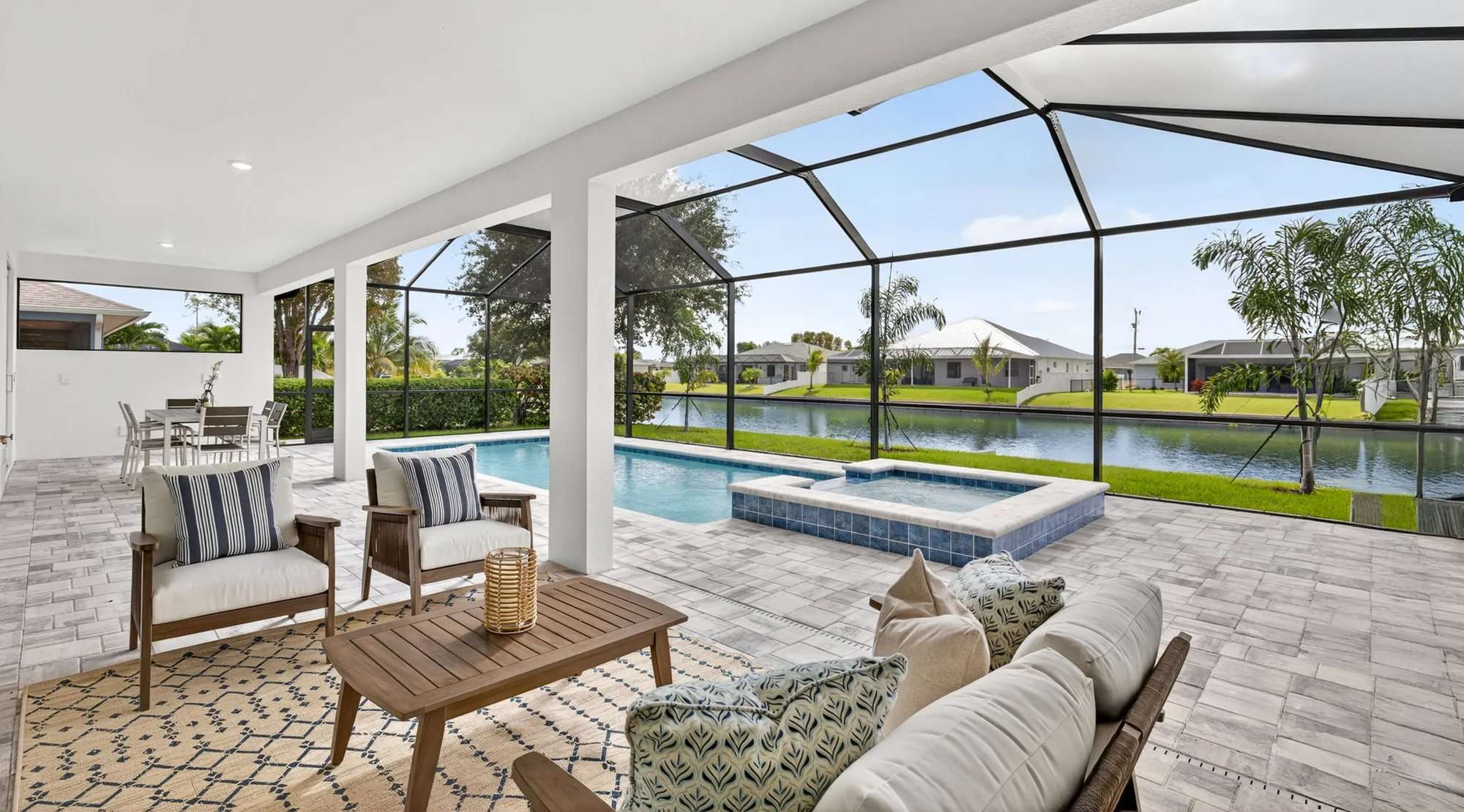 Lanai with pool and spa overlooking a canal at a SunLife Coral Haven