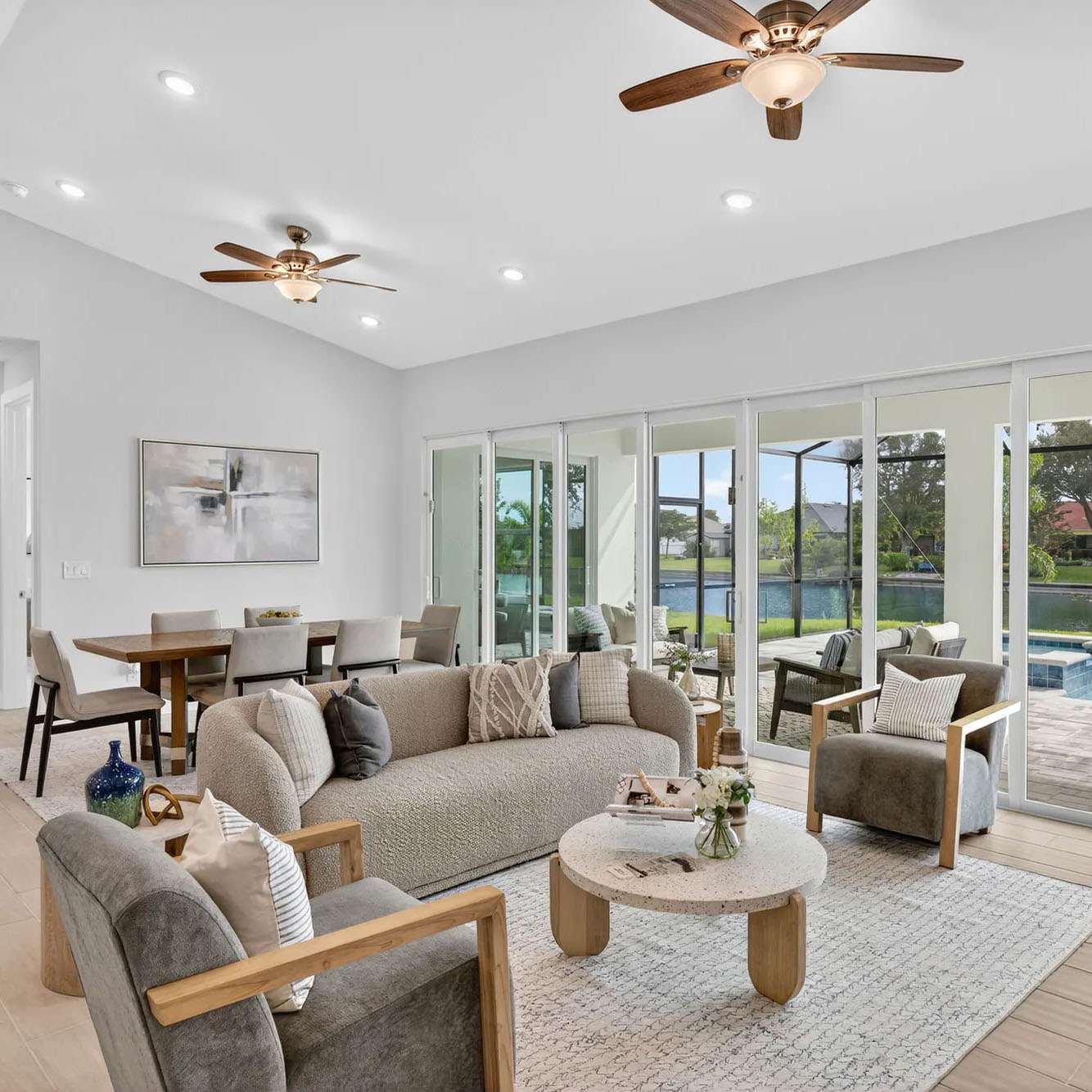 Open living room with sliders to the lanai and pool in a SunLife Coral Haven